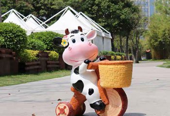 牛雕塑-動(dòng)物園一只騎車的玻璃鋼牛雕塑